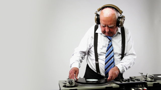 a very funky elderly grandpa dj mixing records