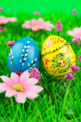 Colorful easter eggs in a row on green grass