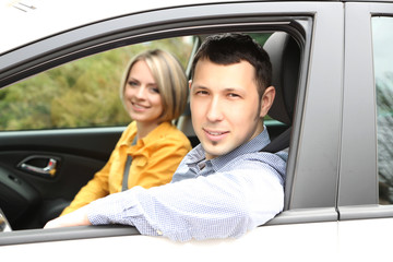 Portrait of young beautiful  couple sitting in the car