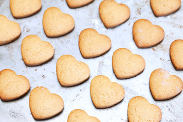 Fototapeta na wymiar Home made shortbread heart shaped cookies on baking tray
