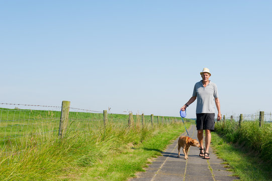 Elderly Man Walking The Dog