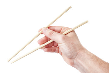Chinese sticks chopsticks, in a man's hand for sushi. On a white