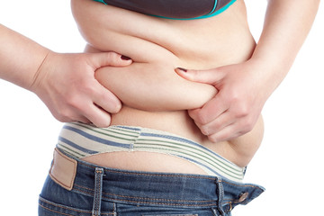 Fat woman picks up a thick layer of the stomach. On a white back
