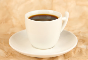 Cup of strong coffee on beige background