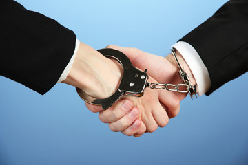 Man and woman hands and breaking handcuffs on color background