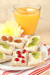 Tasty canapes with cheese, kiwi and cranberry, almond,