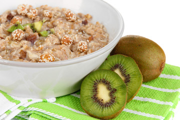 Useful oatmeal in bowl with fruit isolated on white