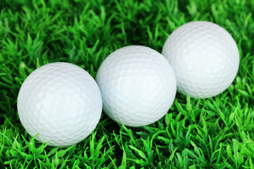 Golf balls on grass close up
