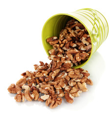 Overturned bucket with nuts isolated on white