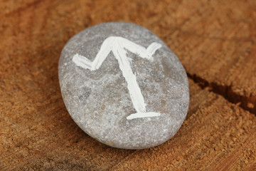 Fortune telling  with symbols on stone on wooden background