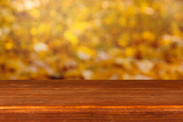 Naklejka na ściany i meble Wooden table on bright yellow background