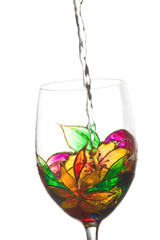 White wine poured in a beautiful  painting stained glass