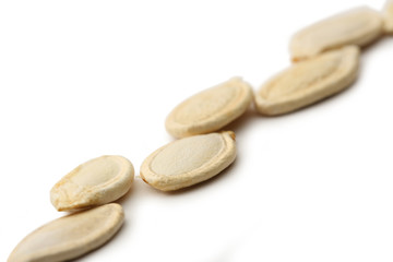 Pumpkin seeds on the white background