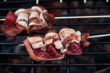 Meat rolls with bacon on grill