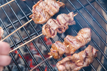 Meat rolls with bacon on grill