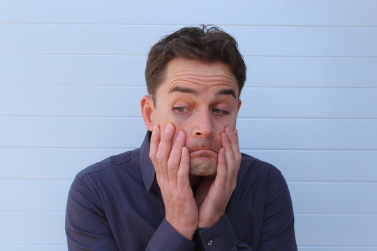 Worried doubtful face of an attractive man
