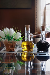 Bottles of olive oil and vinegar on a table in a cafe.