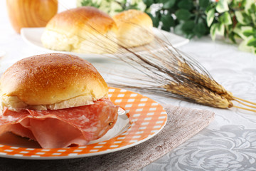 Bread topped with salami and ham