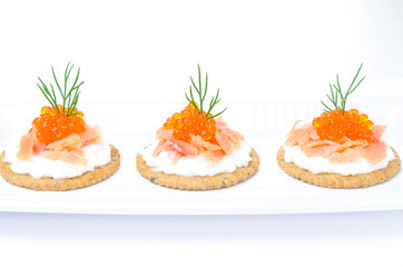 appetizer crackers with cream cheese, salted salmon and caviar