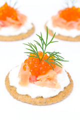 appetizer crackers with cream cheese, salted salmon, red caviar