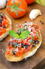 Italian bruschetta with tomato, olives, basil, cheese