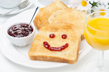 Toast with a smile of jam, coffee, orange juice