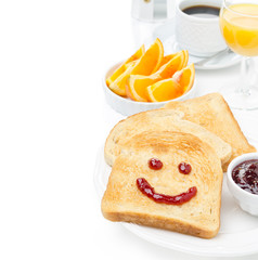 Toast with a smile of jam, coffee, orange juice and fresh orange