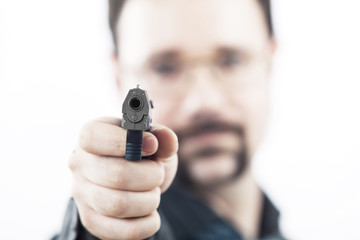 Fototapeta premium man with a gun shooting in our direction