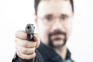 Fototapeta premium man with a gun shooting in our direction