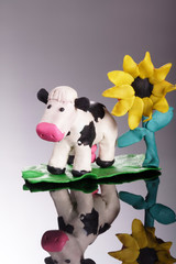 Naklejka premium plasticine cow with flower