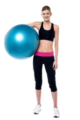 Female fitness trainer holding aerobic ball