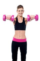 Fototapeta na wymiar Trainer holding dumbbells in her outstretched arms