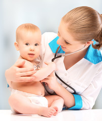 baby and doctor pediatrician. doctor listens to the heart with s