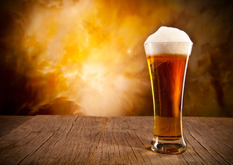 Glass of beer on wooden table