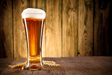 Glass of beer on wooden table
