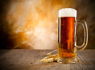 Glass of beer on wooden table