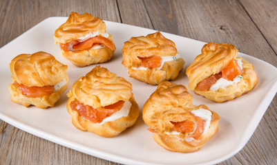 Eclairs and profiteroles filled with cream and salmon