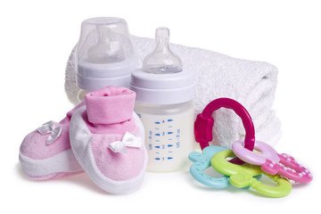 Composition of baby booties, bottles and toy for teething