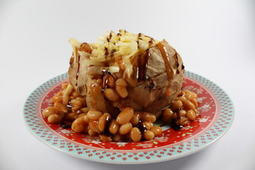 baked potato with cheese and baked beans with balsamic drizzle