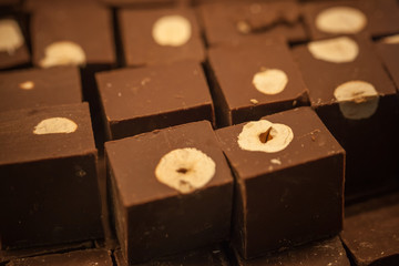 Dark chocolate blocks with hazelnuts on the counter