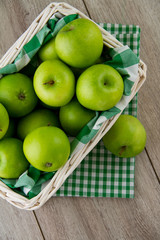 Green apples in white basket