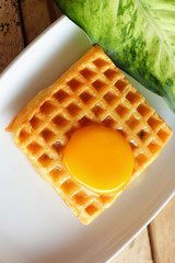 Waffle topped with eggs