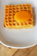Waffle topped with eggs