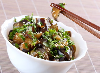 Fried eggplant with coriander and sesame seeds,close up