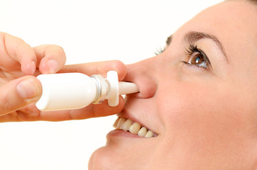 Woman using nasal spray