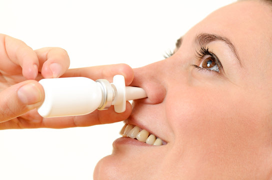 Woman Using Nasal Spray