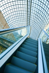 escalators stairway inside  blue glass business centre