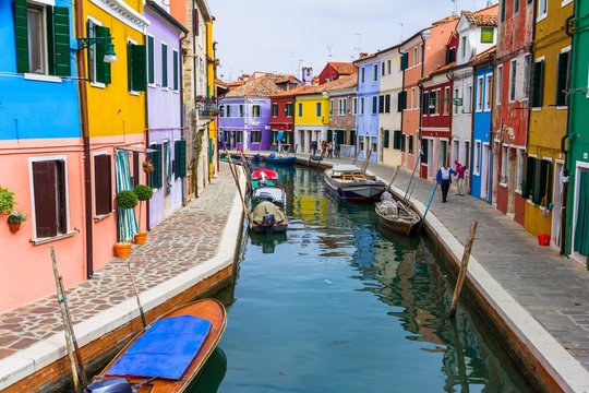 Burano canal full of boats and colorful houses