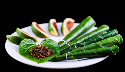 Areca nut, betel nut chewed with the leaf is mild stimulant. - obrazy, fototapety, plakaty