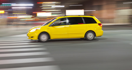 Fototapeta na wymiar Speeding Taxi cab at night in city